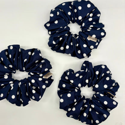 Blackberry Dot oversized polka‑dot scrunchies. Deep navy blue with classic white polka‑dot print, 100% cotton fabric, handmade in Kent, UK, handmade hair accessories, birthday gift or thank‑you gift