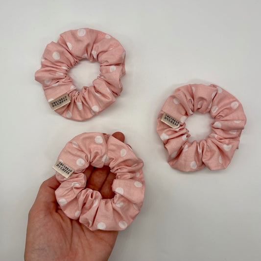 Blush Dot Mini polka dot scrunchie. Soft blush pink with white polka dot design, blush polka dot print. 100% cotton fabric, handmade in Kent, handmade in the UK, hair accessory / ponytail holder, ideal as birthday gift, gift for her or everyday wear.