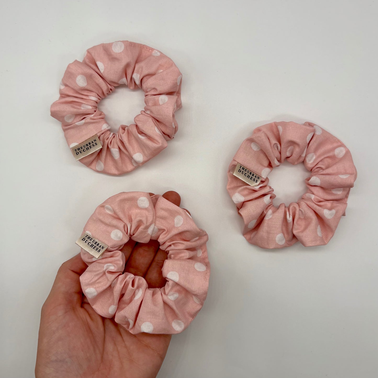 Blush Dot mini polka‑dot scrunchies. Soft blush pink with white spots, 100% cotton fabric hair accessory, handmade in Kent UK, perfect small treat or stocking filler gift