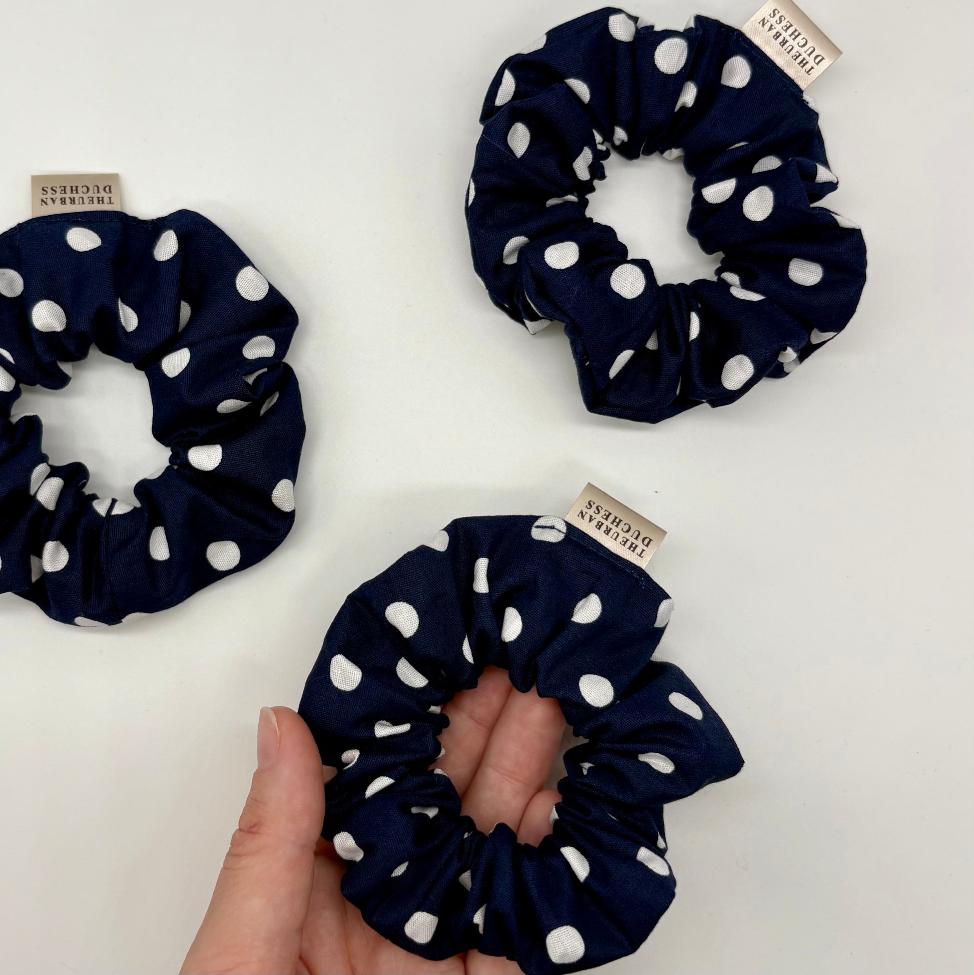 Blackberry Dot mini polka dot scrunchies. Deep navy blue with crisp white polka dots, 100% cotton fabric, handmade in Kent, UK, cute hair ties, great stocking filler or small gift