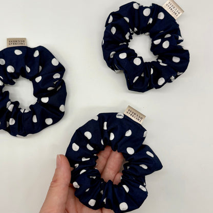 Blackberry Dot mini polka dot scrunchies. Deep navy blue with crisp white polka dots, 100% cotton fabric, handmade in Kent, UK, cute hair ties, great stocking filler or small gift