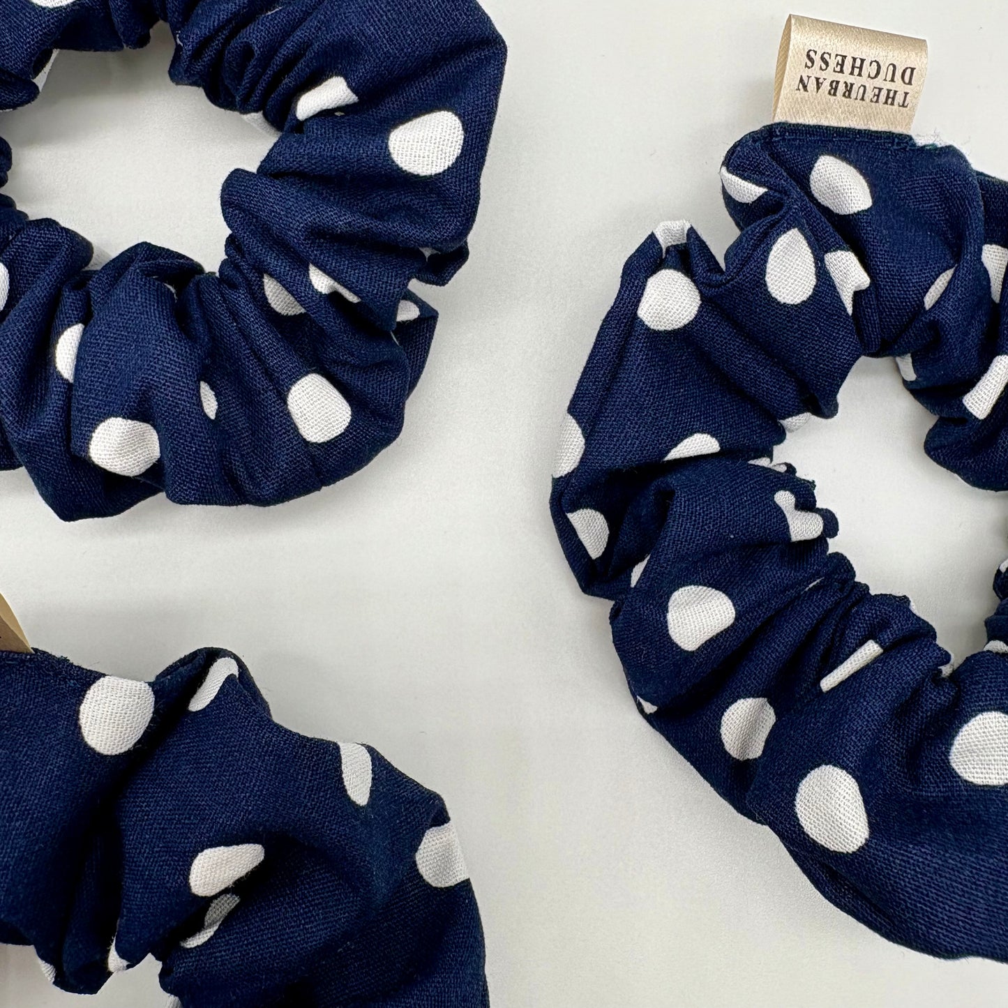 Blackberry Dot oversized polka‑dot scrunchies. Deep navy blue with crisp white polka dots, 100%  cotton fabric, handmade in Kent, UK, The Urban Duchess branded hair accessory, cottagecore style, soft & durable for everyday wear