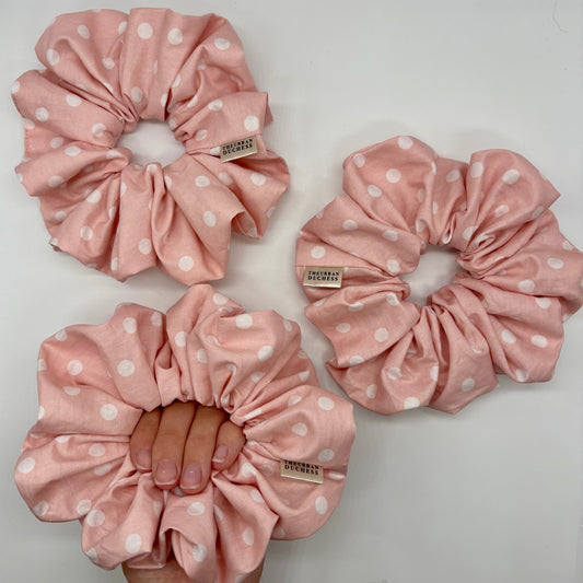 Blush Dot oversized polka dot scrunchie. Soft blush pink with white polka dot design, blush polka dot print. 100% cotton fabric, handmade in Kent, handmade in the UK, cottagecore hair accessory, ideal as a birthday gift, gift for her or everyday wear.