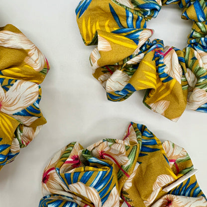 Close‑up of Hibiscus Sun print on oversized cotton scrunchie. Tropical floral pattern, breathable fabric, handmade in Kent, gentle on all hair types.